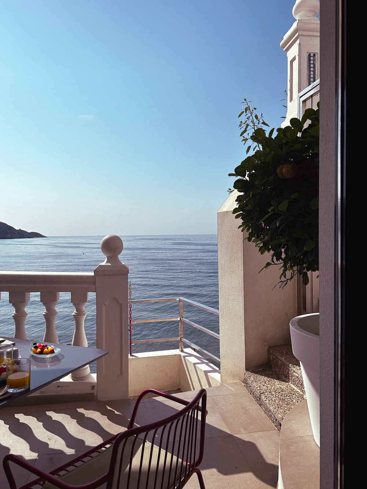 Lamar Denon summer sanctuary - candle on a Mediterranean terrace at morning